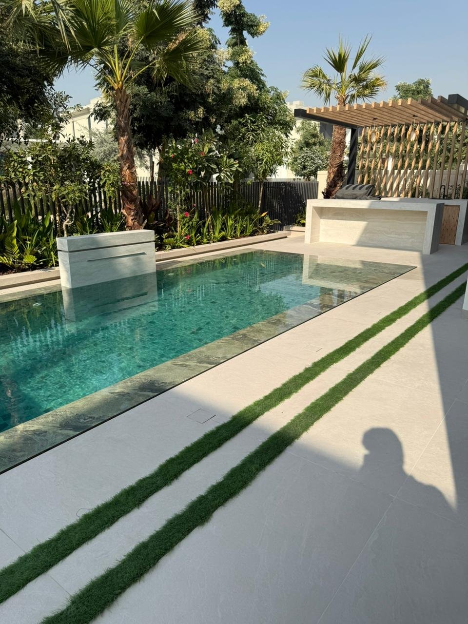 Landscaped garden with artificial lawn, LED steps and terracing
