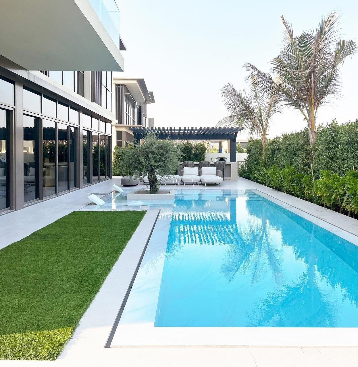 Contemporary pool with stepping stones and palms