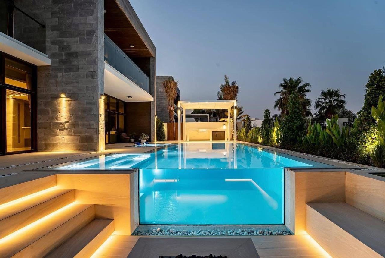 Glass-walled luxury pool at dusk