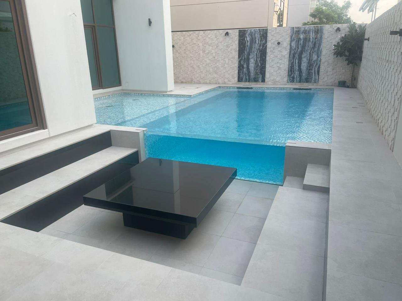 Sunken seating area with fire feature by the pool