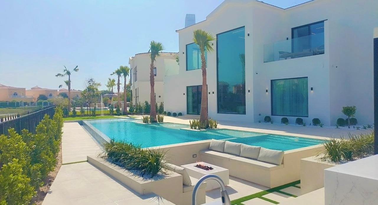 Landscaped garden with artificial lawn and feature lighting