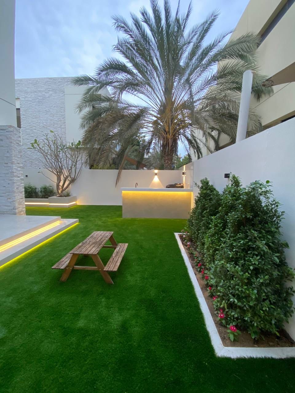 Built-in outdoor kitchen with integrated BBQ and LED lighting