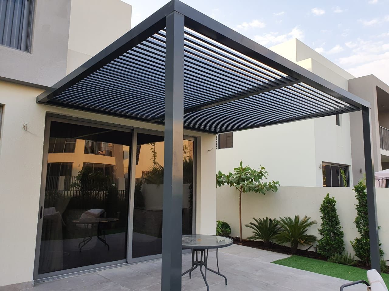 Modern louvre pergola installed in Dubai villa garden